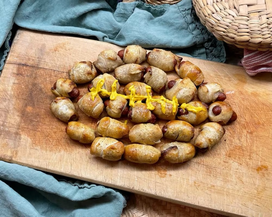 Pigs in a blanket arranged into a football, from Kick Off Your Super Bowl Party
